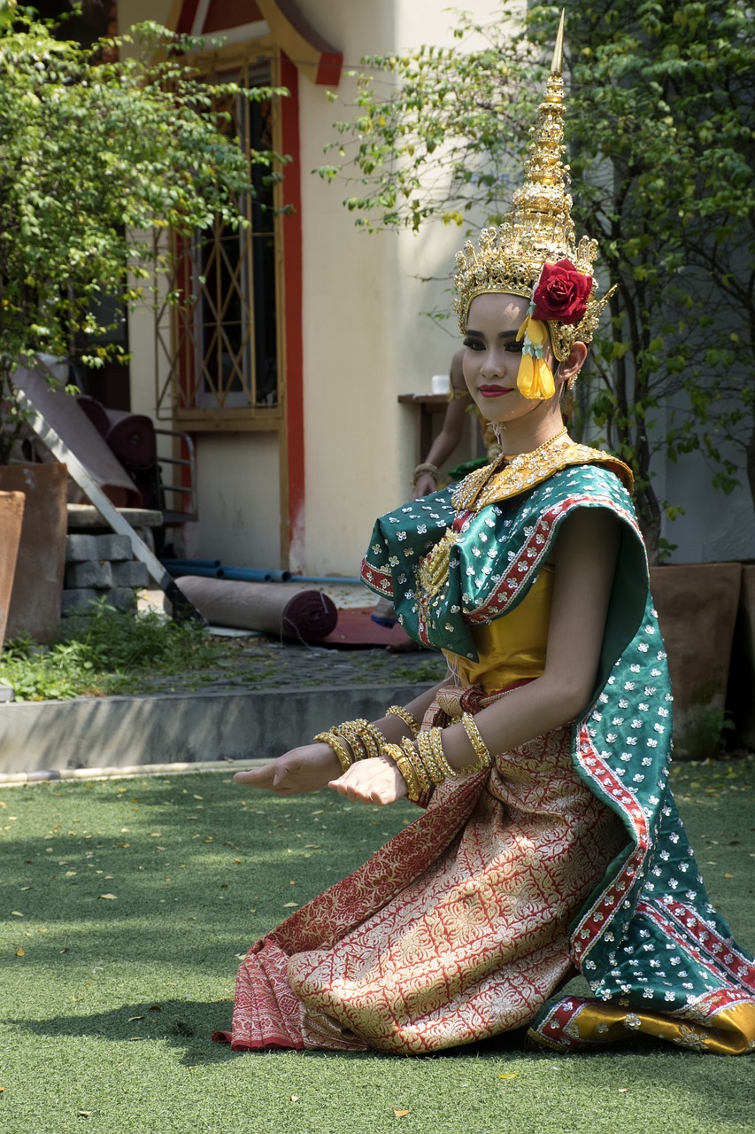 a beautiful Thai woman dancing in a traditional costume