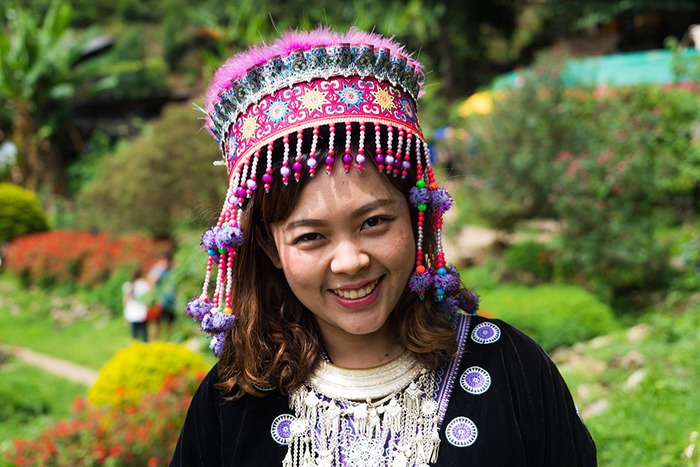 A woman smiling while wearing a Chiang Mai costume