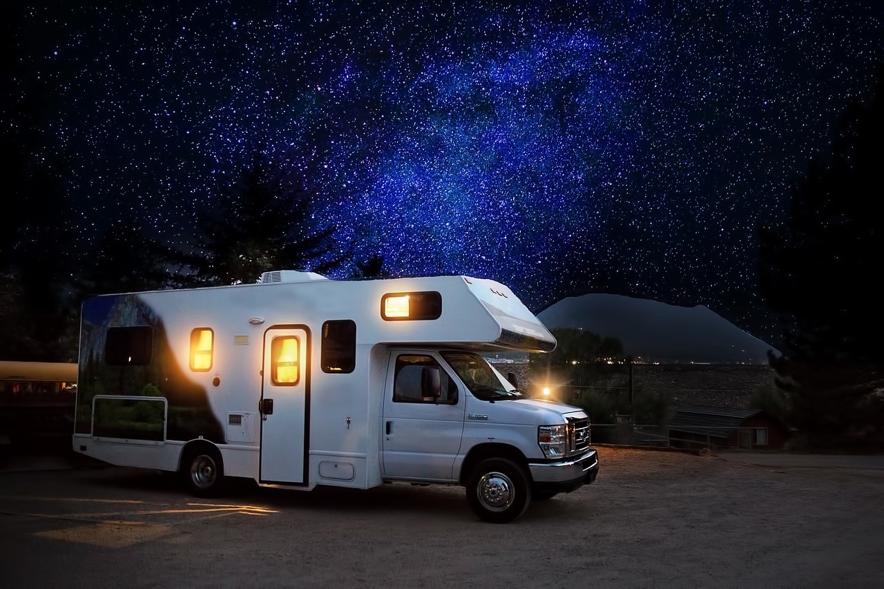RV parked in a field at night