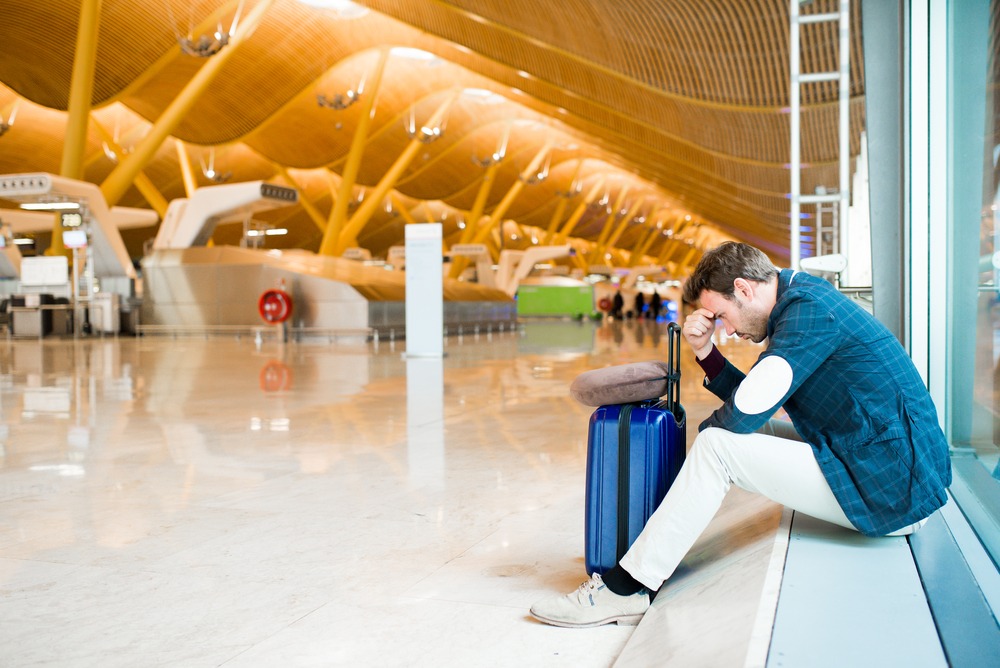 Man upset, sad and angry at the airport his flight is delayed