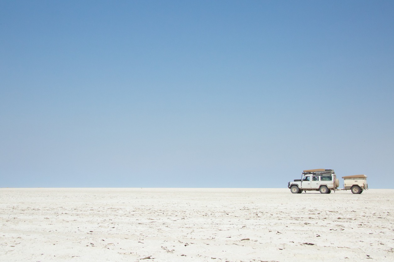 SUV traveling through Botswana's salt flats