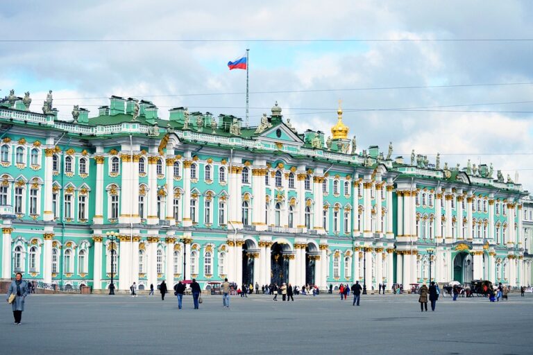 blue-green and white building, flag of Russia on the roof, people walking