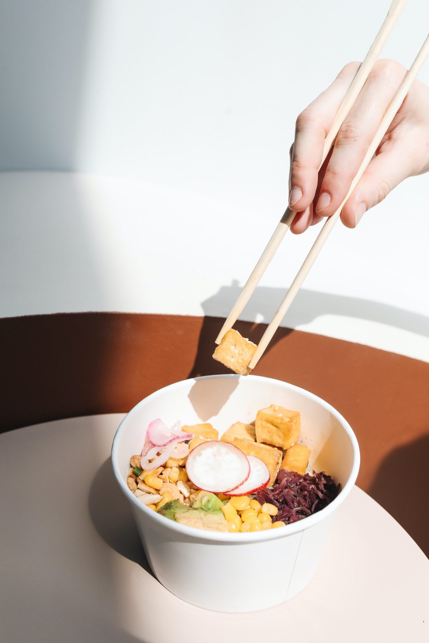 chopsticks-pulling-food-out-of-poke-bowl