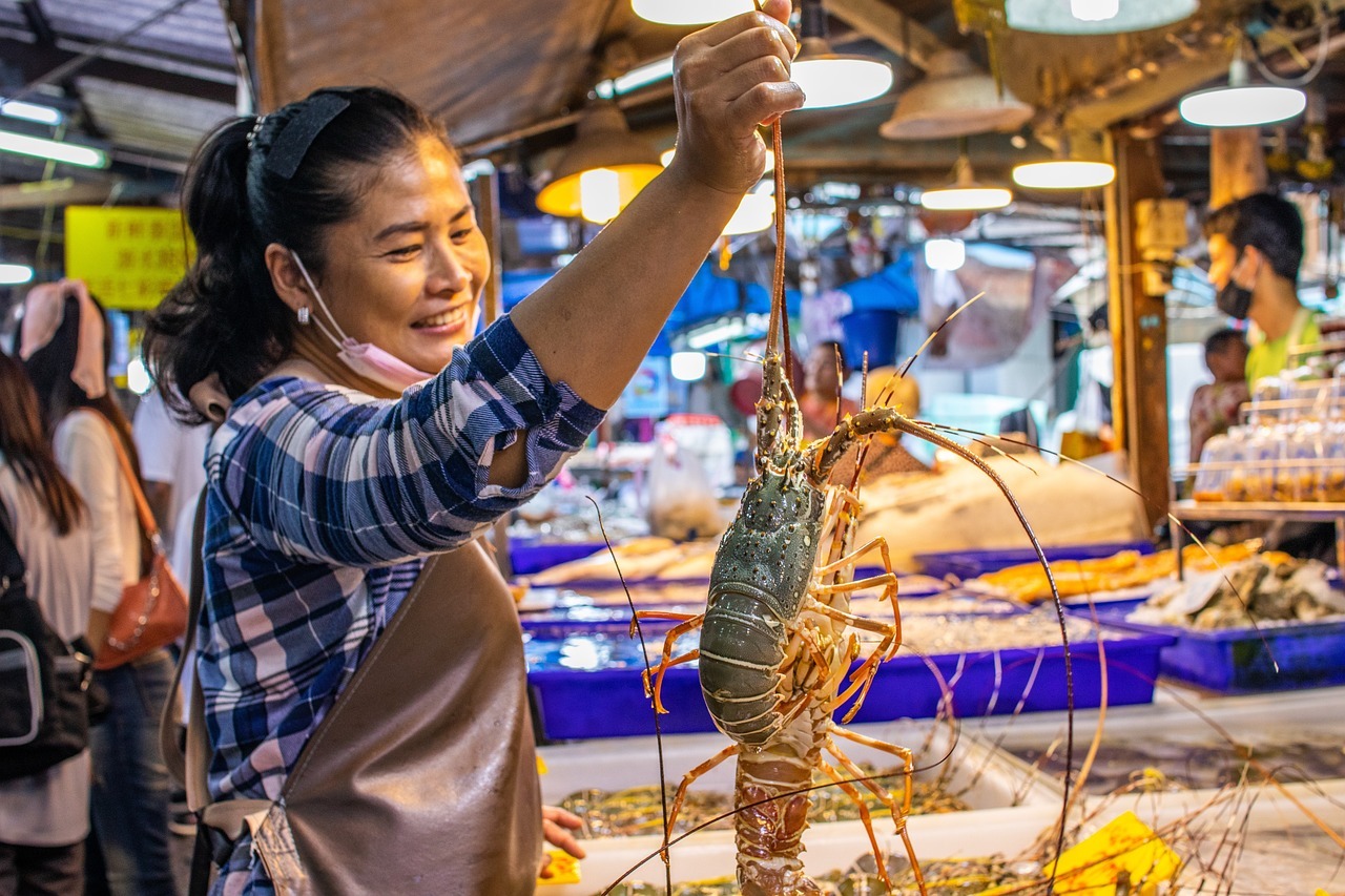 woman selling lobster in Thai market