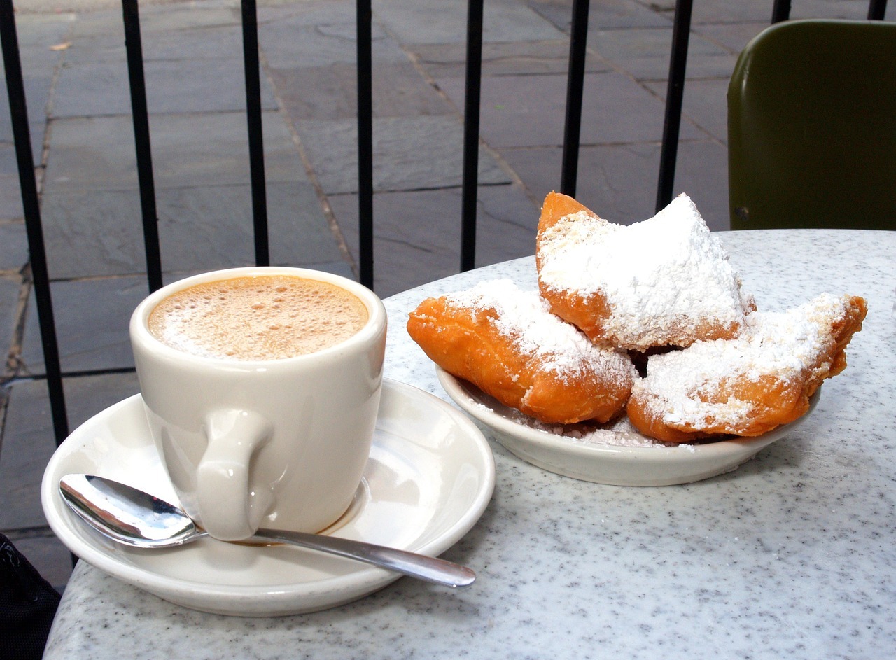 a cup of coffee and beignets
