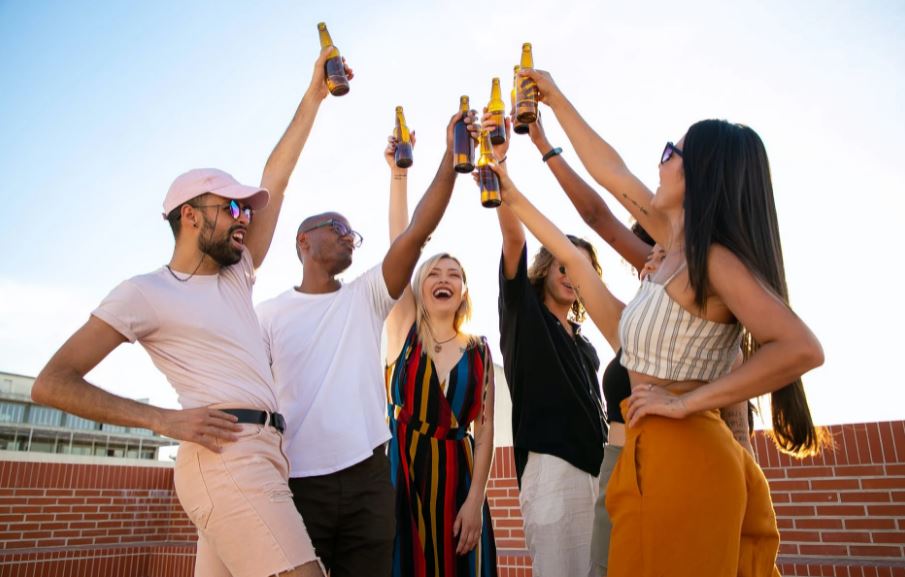 a-group-of-friends-clinking-beer-bottles
