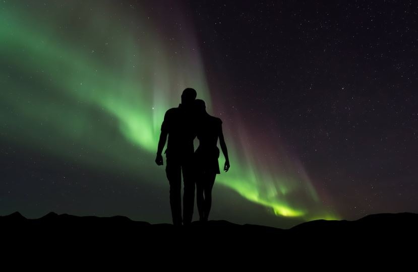 silhouette of people watching the northern lights, aurora borealis or northern lights